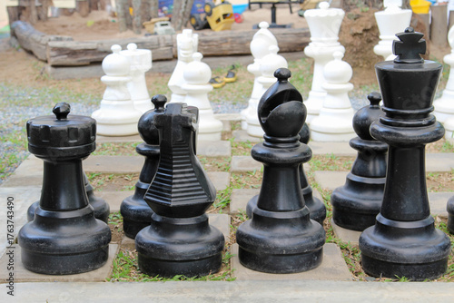A giant outdoor chess set on green grass