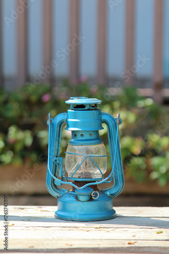 A blue old vintage lamp on a old wooden crate