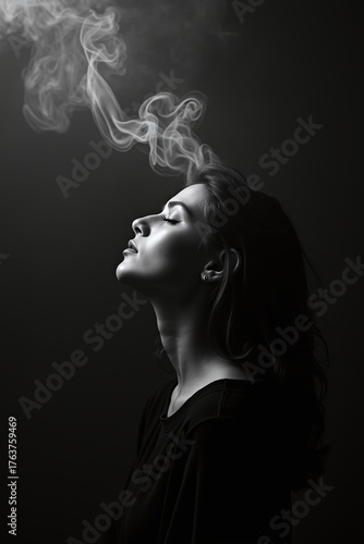 Minimal monochrome photo of serene woman and soft smoke.