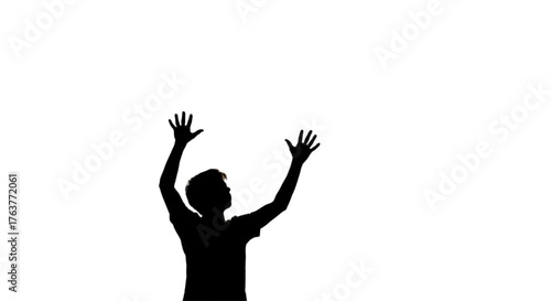 Silhouette of Man with Hands Raised to Sky Expressing Freedom, Hope, or Worship