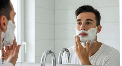 Man applying shaving cream in the bathroom mirror