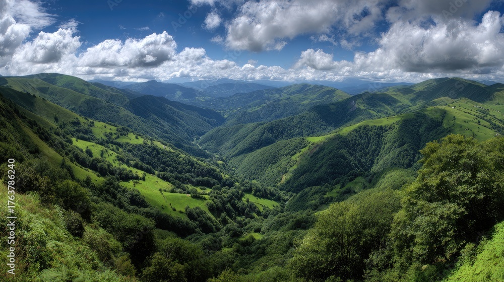 Naklejka premium Lush, rolling green hills and valleys under a dramatic sky