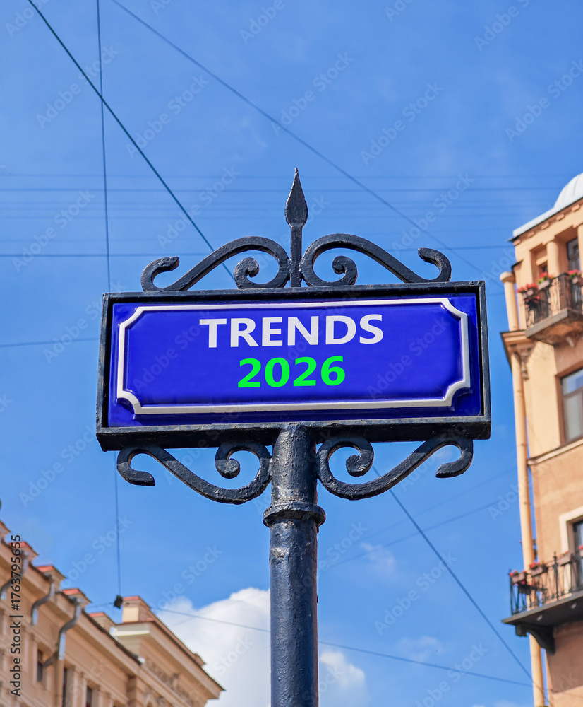 Obraz premium Trends 2026 new year symbol. Concept words Trends 2026 on beautiful blue road sign. Beautiful blue sky and buildings background. Business and Trends 2026 new year concept. Copy space.