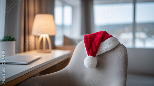 Santa hat resting on a modern office chair at the end of the day