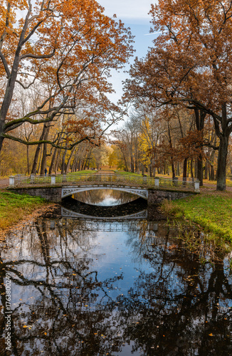 Colorful autumn landscape with reflection in the water of the Cross Canal.  Tsarskoe Selo, Pushkin, Saint Petersburg, Russia.