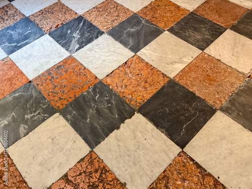 Vintage checkered marble floor with red, black, and white tiles