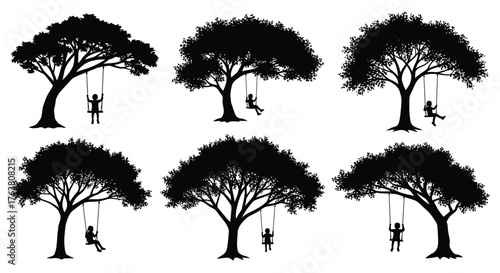 Silhouettes of trees with children swinging on swings a playful scene