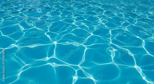 Turquoise water surface with sunlight reflections creating abstract patterns and shimmering effects on the water