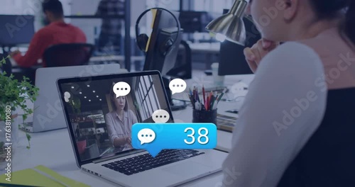 Tech professional watching webinar at desk reacting to chat bubble showing rising engagement