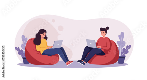 People working remotely on laptops while sitting on bean bags in a cozy setting