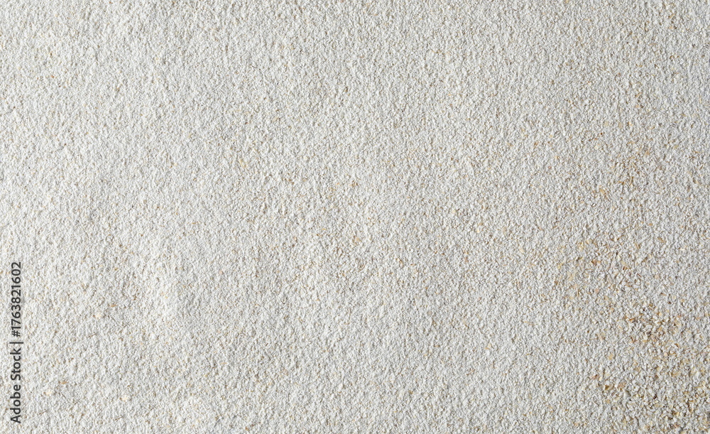 Fototapeta premium Pile of integral barley flour background and texture, top view