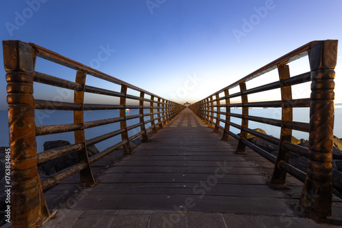 Beautiful Fishing bridge during the early sunrise at Arabian sea near to Kuwait Tower
