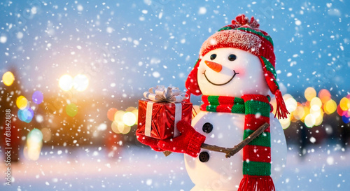 A festive snowman with a colorful hat and scarf stands in the snow, holding a shiny, wrapped present, ready to spread holiday cheer.