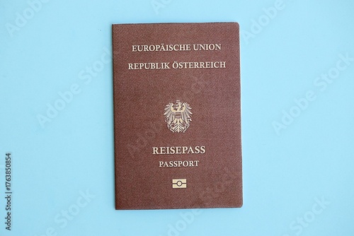 Canvas Print Austria passport on light blue paper background close up
