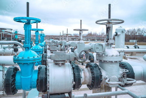 Industrial area. Industrial valve instalation in petrochemical area. Valves with electrical control.