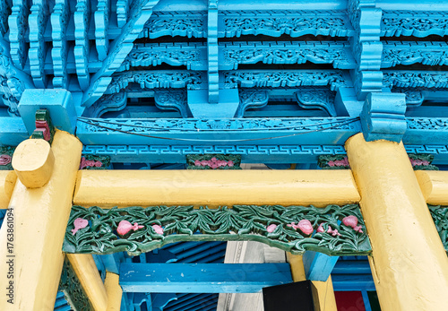 Vibrant Blue and Yellow Carved Eaves of Dungan Mosque in Karakol, Kyrgyzstan