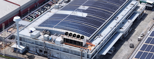 Cooling towers in data center building. Air conditioning cooling towers in front of building with fins to the front. Industrial cooling towers or air cooled water chillers with piping system.