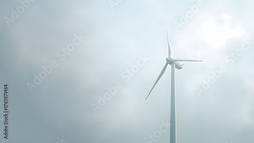 Minimal wind turbine icon on a cloudy background, isolated with left-side copyspace. Symbolizing renewable energy and sustainability.