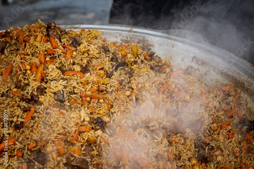 A large bowl of food with rice and carrots