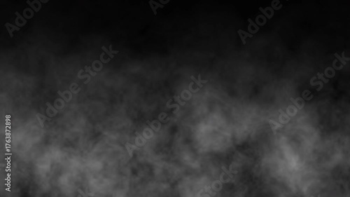 White smoke or fog rises and floating as storm swirl to the top on dark copy space background. White steam rising on black backdrop. smoke on black background