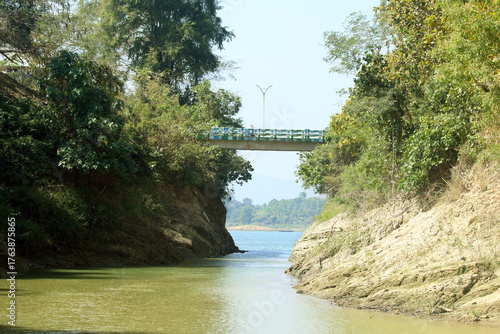 Green Hills and Sparkling Lake under Blue Sky