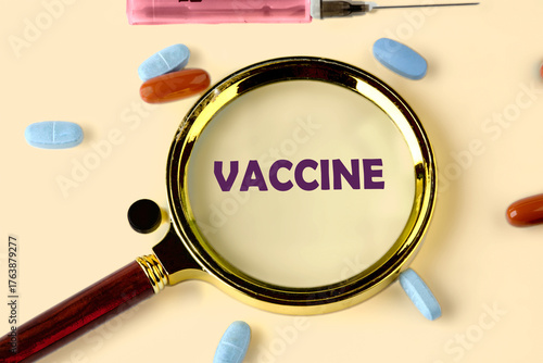 A magnifying glass focuses on the word vaccine, surrounded by colorful pills and a syringe. This scene emphasizes the significance of vaccinations in health and wellness