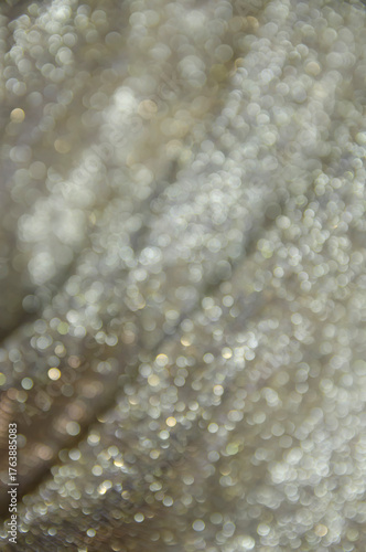 Beige shiny background. Fabric screensaver. Festive decoration.