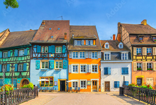 Colorful houses medieval buildings half-timbered style on Quai de la Poissonner in The Fishmonger’s district old town Colmar city historic centre in sunny summer day, Alsace Grand Est region, France