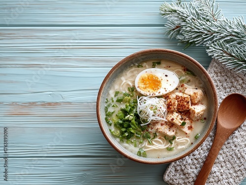 Warm Chicken Ramen Noodle Soup with Soft-Boiled Egg and Fresh Scallions on a Rustic Winter Wood Table