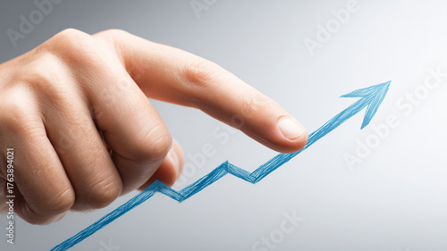 Hand directing a rising sketch arrow illustrating strategy shaping business growth momentum and performance improvement through deliberate action and analytics.
