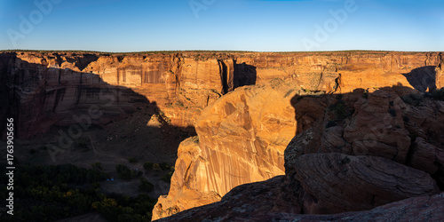Canyon de Chelly National Monument within boundaries of the Navajo Nation in Arizona. Sun setting over Spring Canyon as seen from South Rim Sliding House Overlook.
