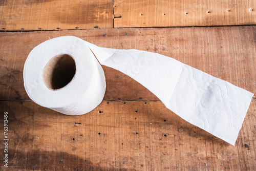 Worn toilet paper on an old wooden table