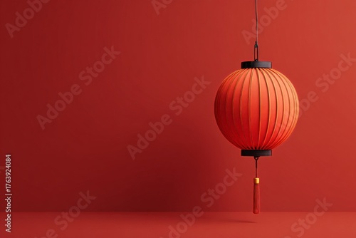 Vibrant Red Lantern Hangs Against a Solid Red Wall Creating a Warm Atmosphere...