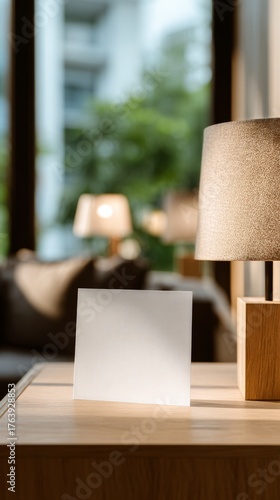 Cozy Interior With a Lamp and Blank Card on a Wooden Table in a Modern Living...