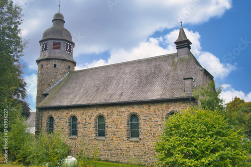 The St. Michael Kirche (Church) in Holthausen, municipality of Schmallenberg,  built in 1927 from greywacke-sandstone. Sauerland, Nordrhein-Westfalen, Germany
