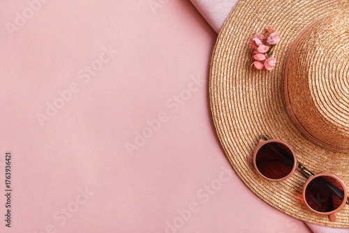 Summer Accessories Arranged on a Pink Surface for a Stylish Vacation Look
