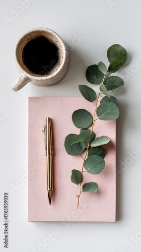 Cozy Workspace With Coffee, Notebook, and Eucalyptus on a Simple Surface