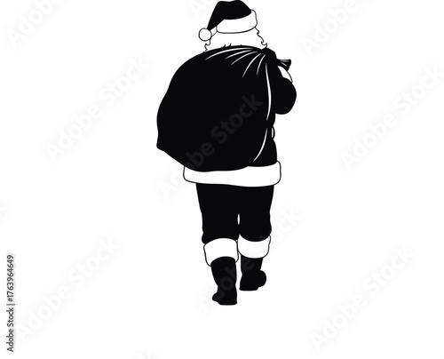 Silhouette of santa claus walking away carrying a large sack of presents on christmas eve