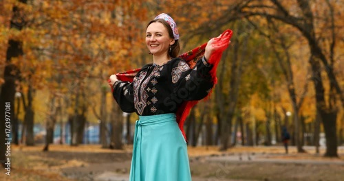 Young beautiful woman in a headscarf in an autumn park