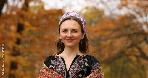 Young beautiful woman in a headscarf in an autumn park