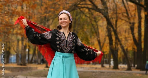 Young beautiful woman in a headscarf in an autumn park