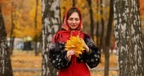 Young beautiful woman in a headscarf in an autumn park