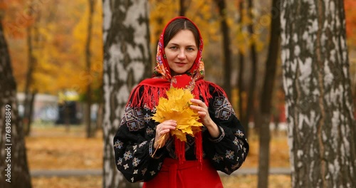 Young beautiful woman in a headscarf in an autumn park