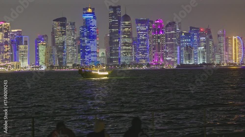 Doha  Qatar skyline at night from the museum of Islamic art with Dows and light reflection in the Arabic gulf 