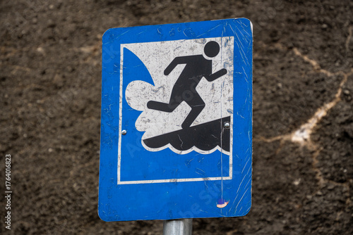 Tsunami Sign Blue, white and man run