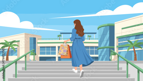 Rear view of a woman in a blue dress ascending stairs with shopping bags, heading towards a modern shopping mall with large glass windows and palm trees under a clear blue sky with wispy clouds