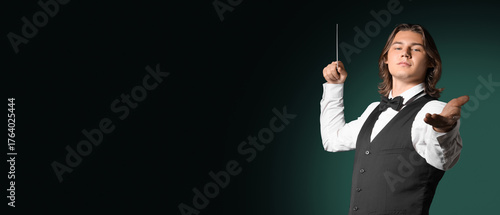 Male conductor on dark gree...