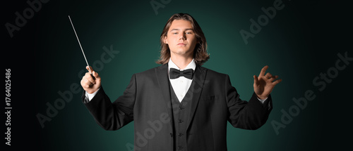 Male conductor on dark gree...