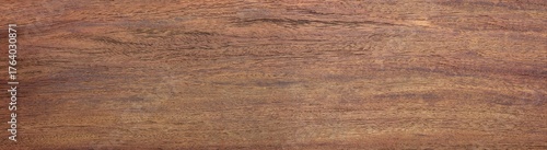 Vintage padauk wood (Pterocarpus soyauxii)  wood texture, in wide format. Raw unfinished surface. Strong, stable hardwoods known for their reddish-brown coloration, which darkens and fades with age.