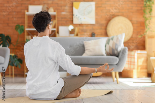 Young man meditating on yog...